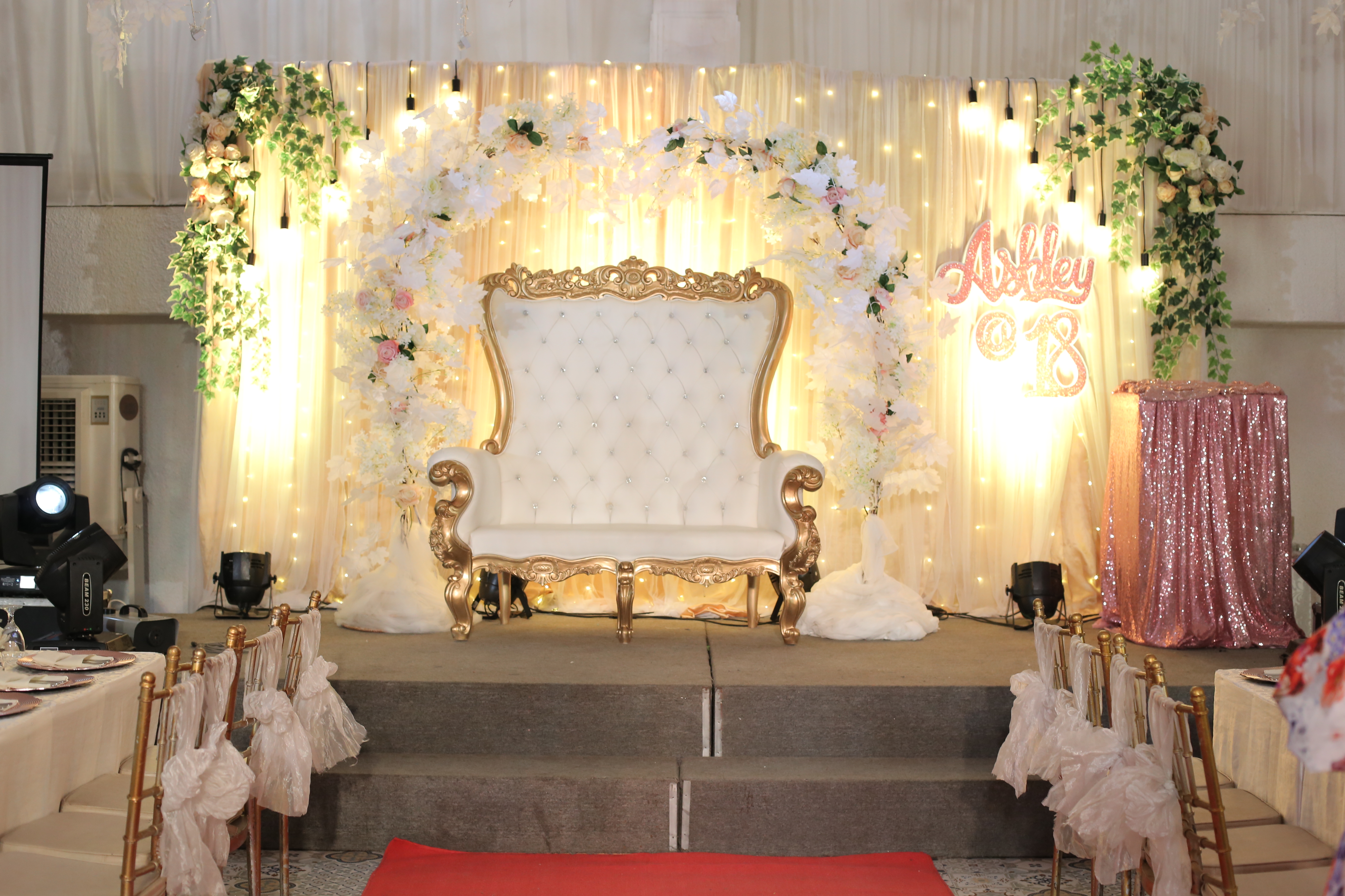 Celebration stage backdrop with florals